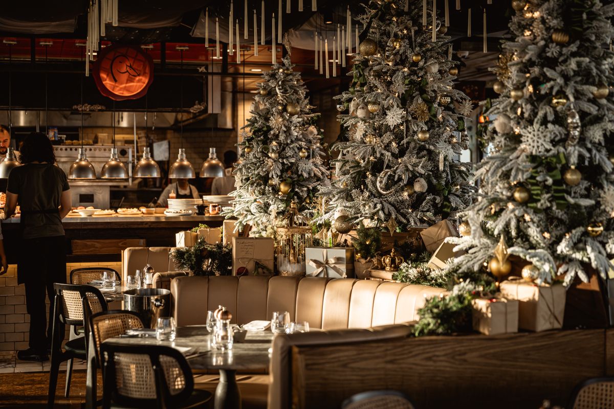 The inside of Duck and Waffle restaurant with multiple highly-decorated Christmas trees