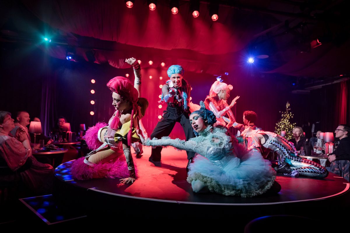 Performers dancing on the stage in colourful outfits