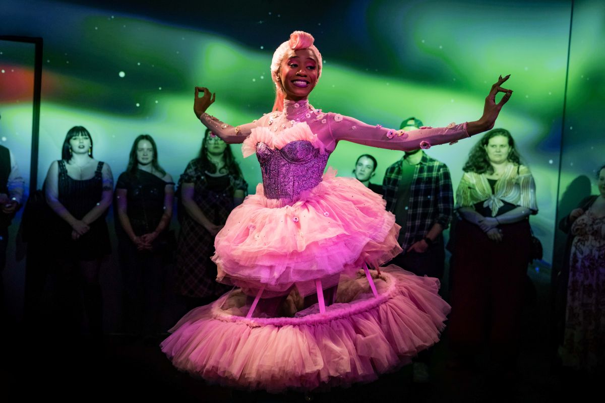 Clara, actress in a pink dress is dancing around