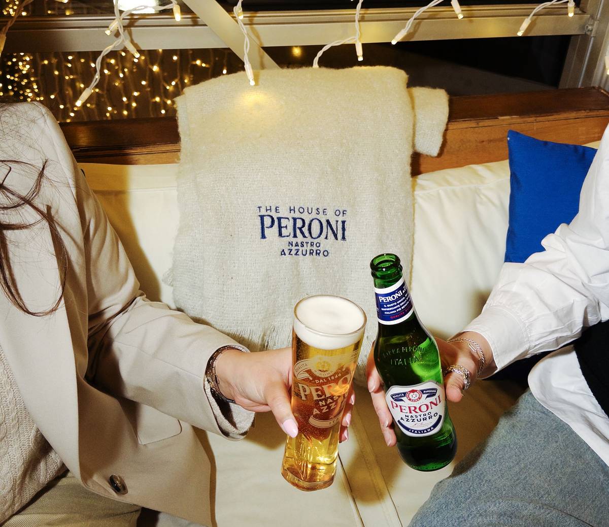 two people cheersing Peroni beer with just their arms in shot
