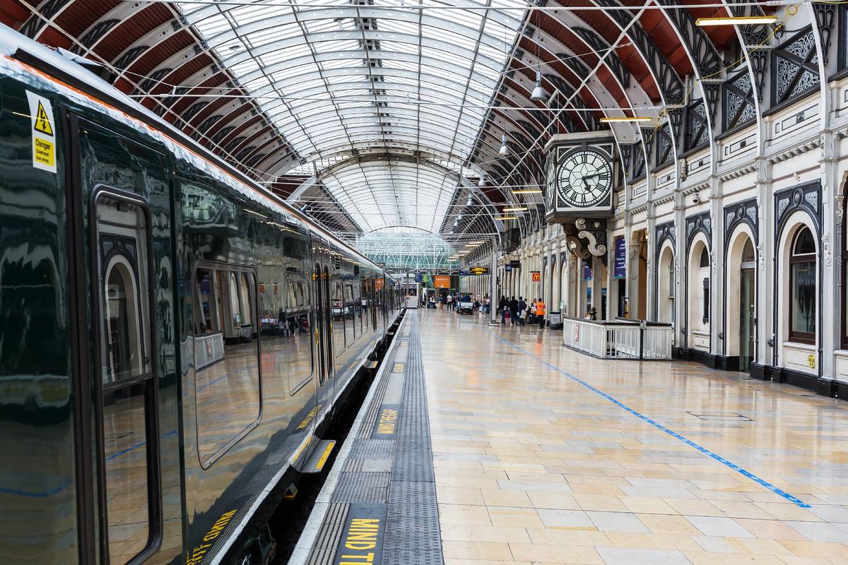 A train pulled into a platform at Paddington station with the high domed ceiling