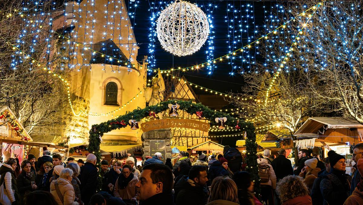Eguisheim, France - December 23, 2023: Traditional Christmas market in medieval town of Eguisheim in Alsace along the wine road - blue hour