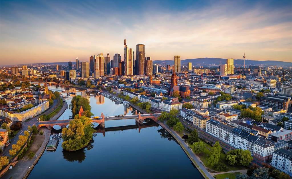 An aerial view of the Frankfurt skyline and a river running through the city