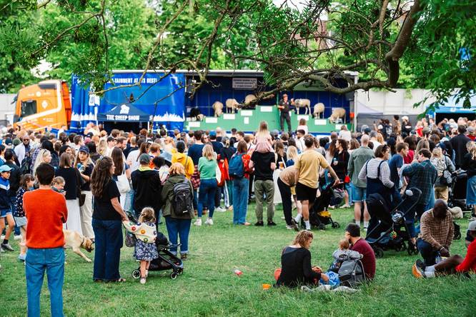 Crowd at the Lambeth Country Show with sheep in the distance