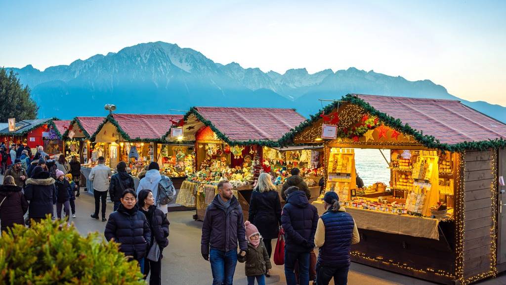 Montreux Christmas Market chalets with the mountains in the background