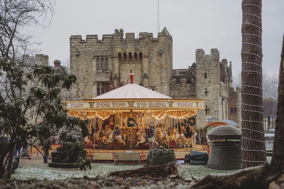 carousel in front of hever castle with children playing