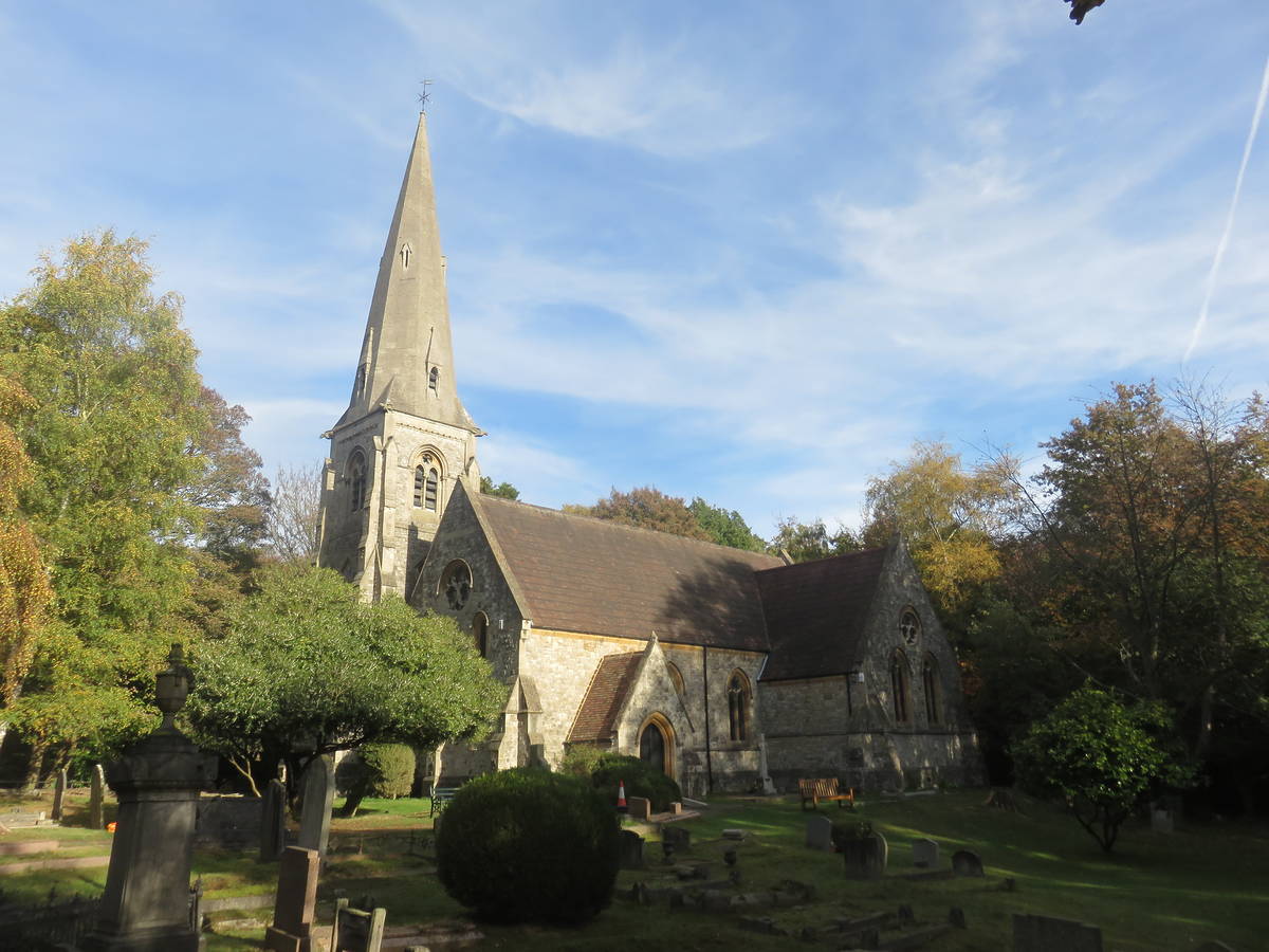 the exterior of the almost 200 year old holy innocents church surrounded by trees