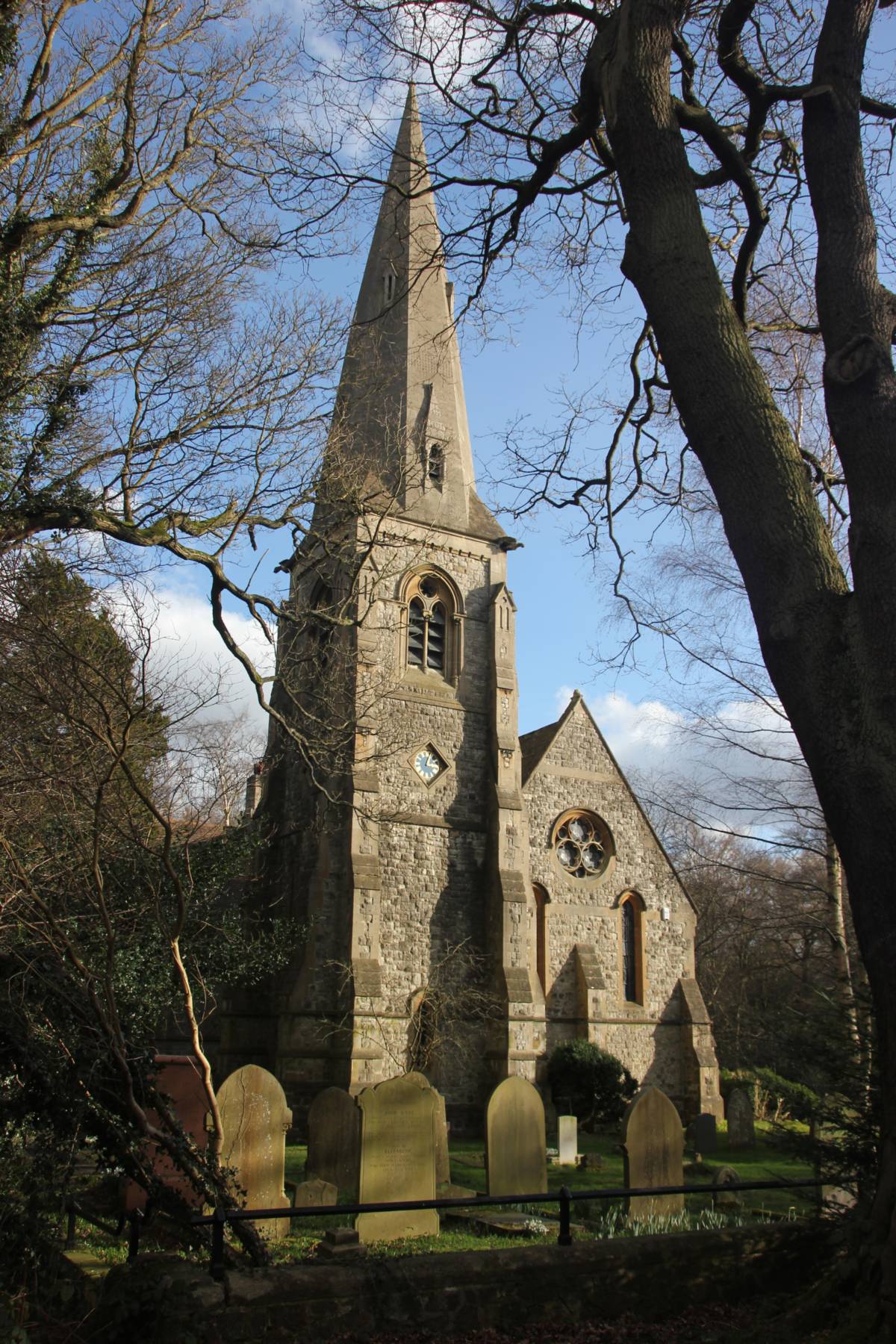 a front on view of the turreted building stretching out above a small church