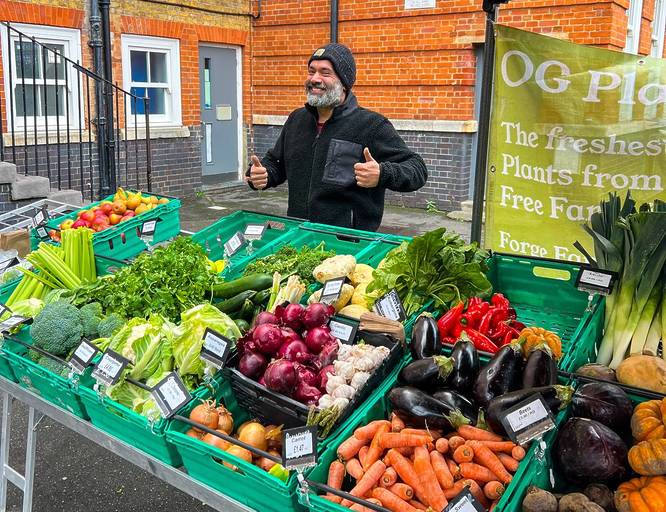 Man behind a stall at a Farmers Marker