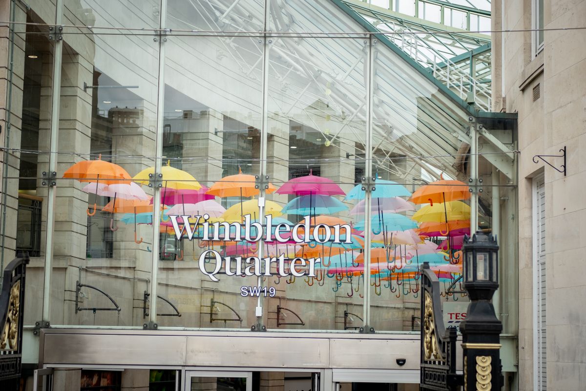The entrance to Wimbledon Quarter shopping centre, decorated with colourful umbrellas