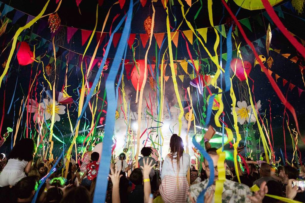 Raver tots festival, children dancing with confetti and decorations falling down