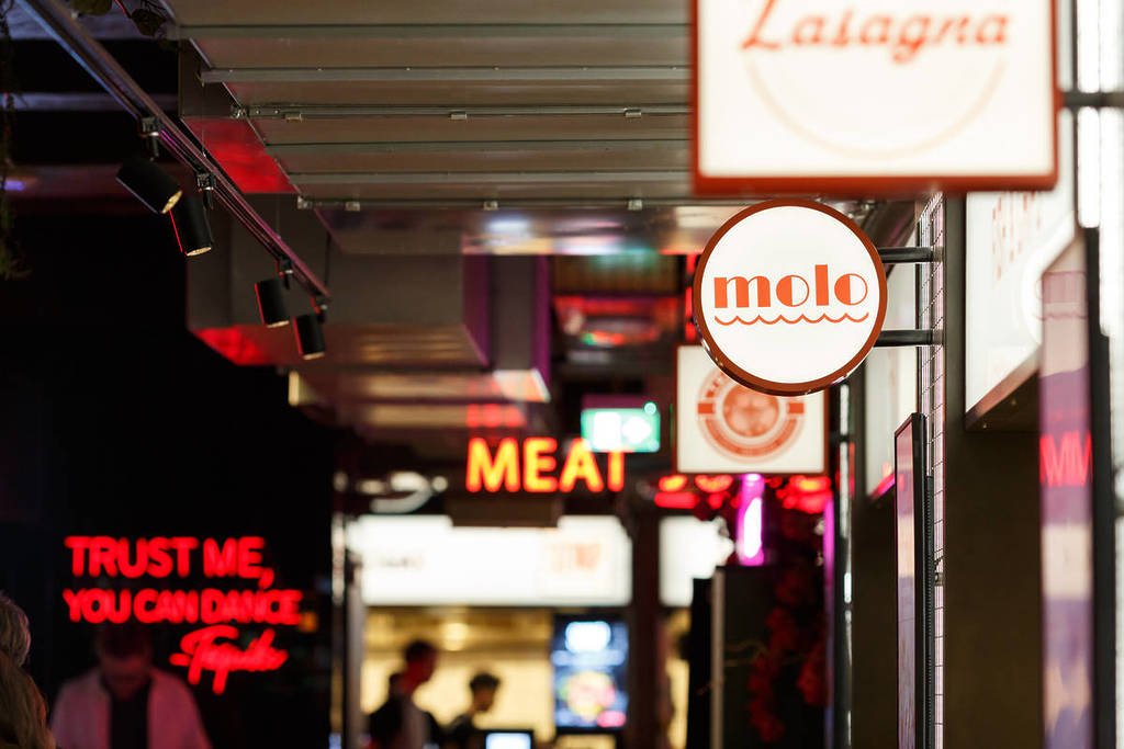 a selection of signs for street food vendors in a market place venue