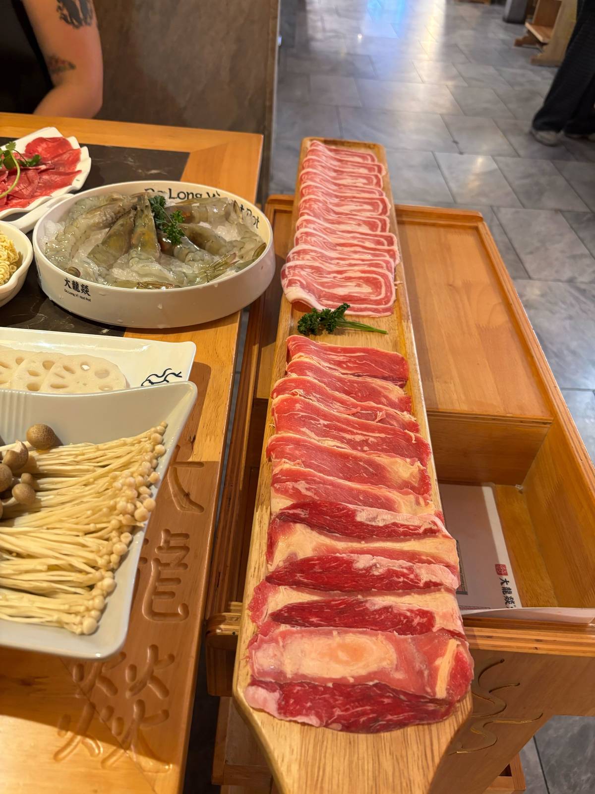 a metre long tray of raw beef and lamb slices