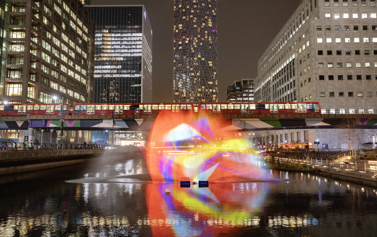 a dancing light display on the water at canary wharf