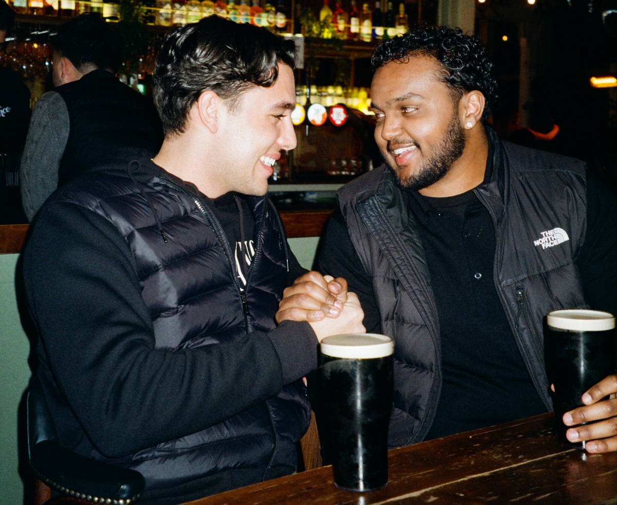 Two people enjoying a Guinness at The Prince pub in London.