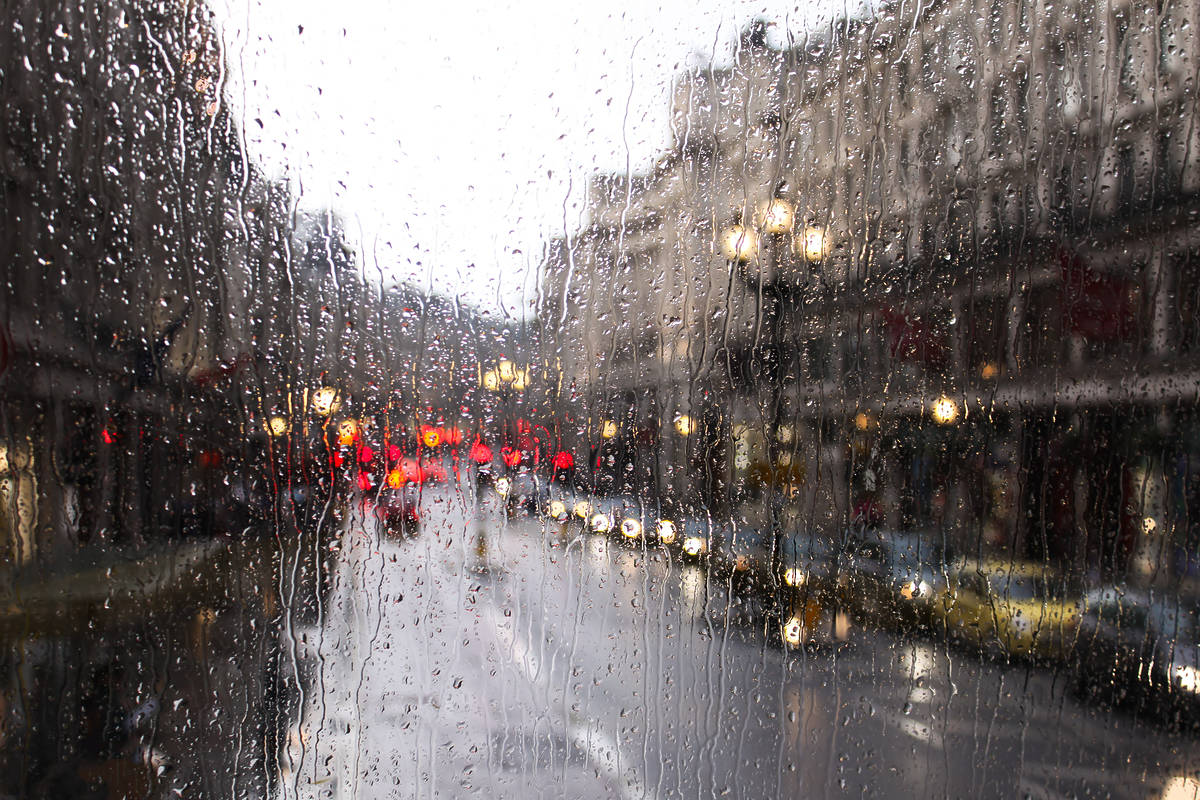 a blurry view of a london street through a rainy window