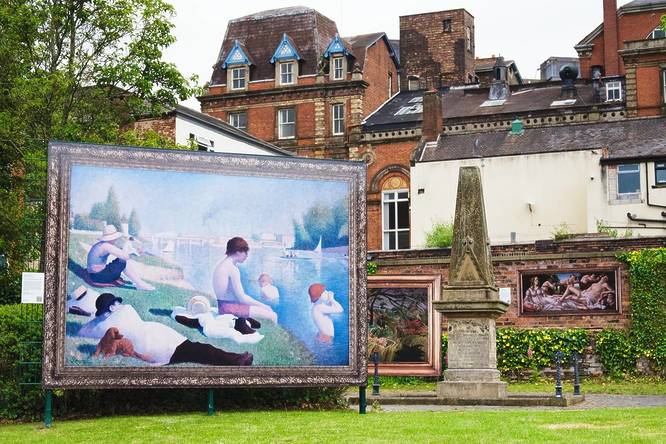 a large painting in an ornate frame on display in a park in stoke on trent