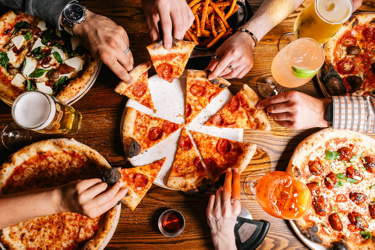 friends sharing pizza at Box Park