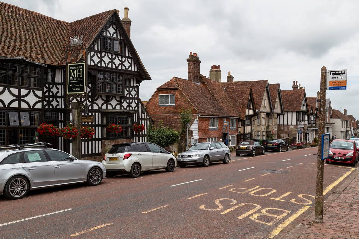 The high street in Mayfield with cars parked down in