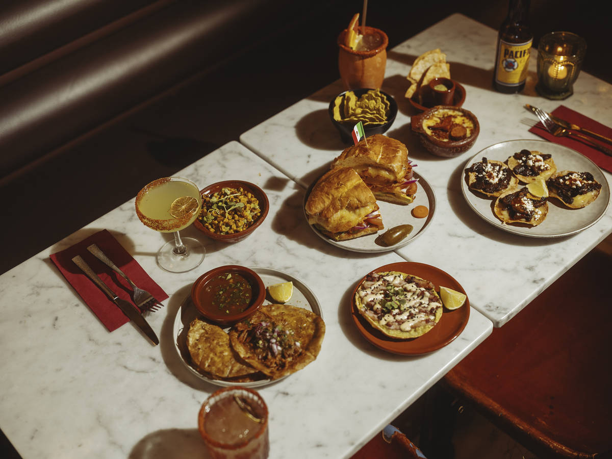a spread of mexican food and cocktails on a table
