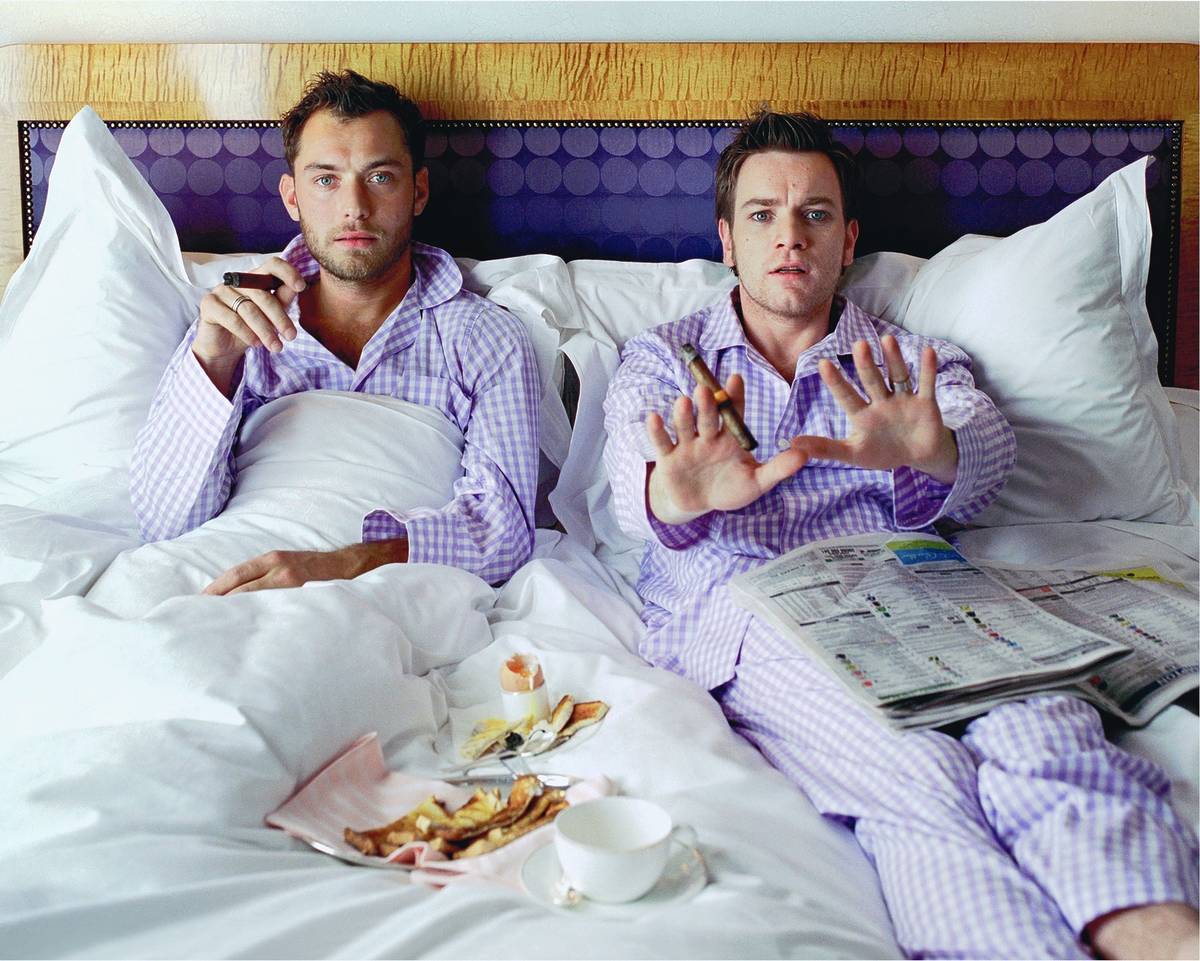 a photograph of actors jude law and ewan mcgregor in bed