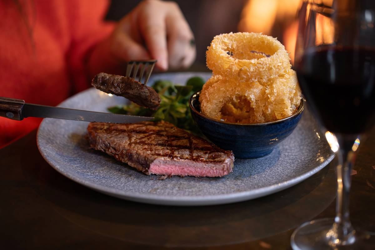 steak and onion rings served on a plate