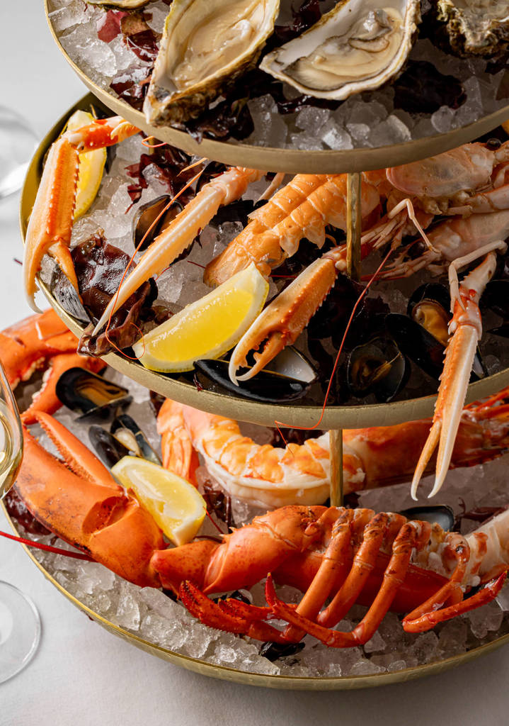 a seafood tower with langoustines, lobster, and more