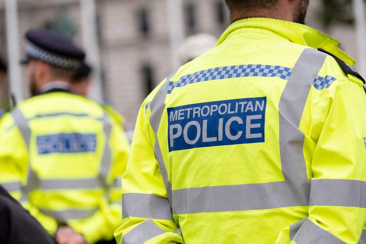 Metropolitan Police sign on the back of a high visibility jacket worn by police officers