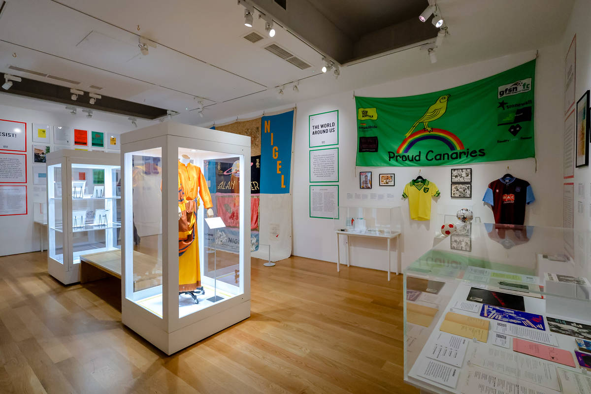 a room in the queer britain museum with various exhibition pieces