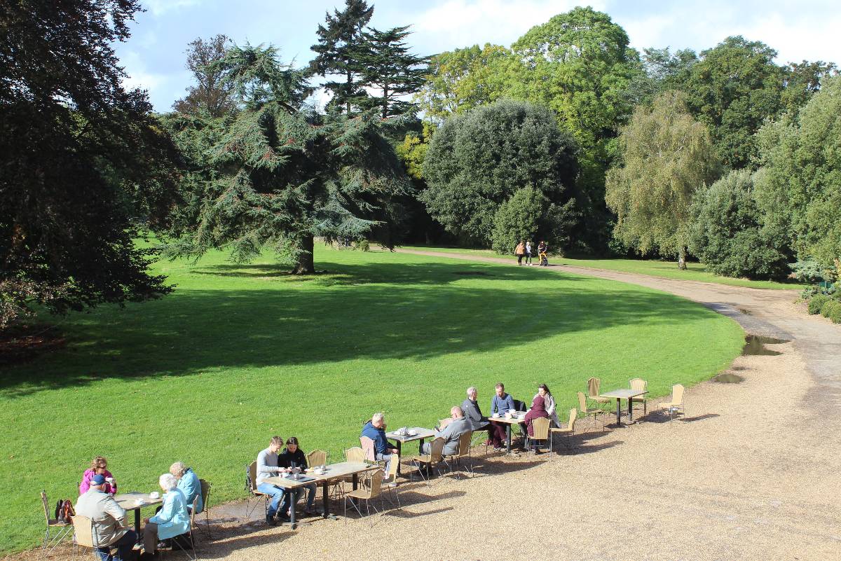 People having afternoon tea in the grounds outside of Basildon House near London