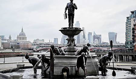 a fountain with statues of people bent over 'throwing up' dirty water from their mouths