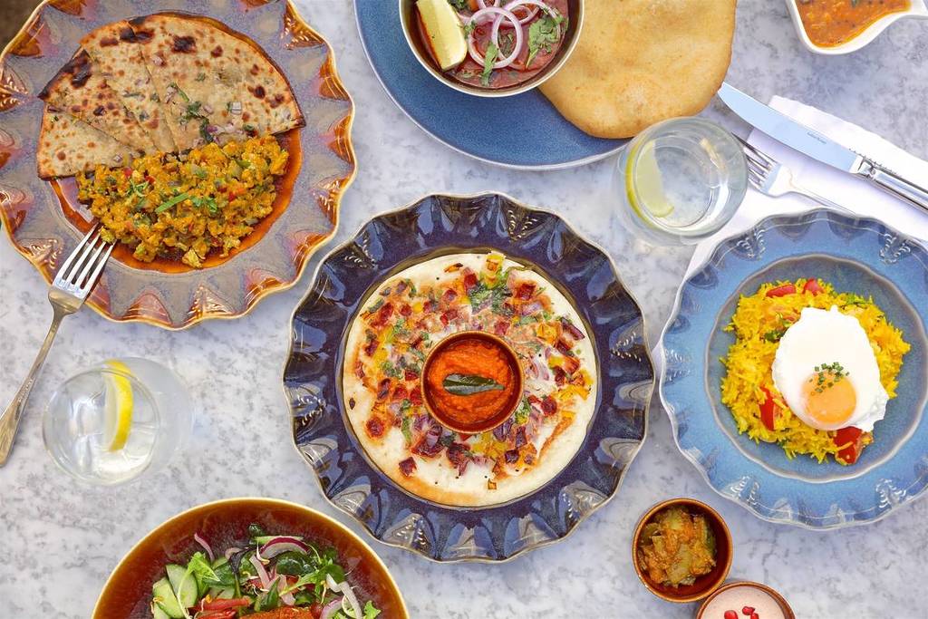 an array of vibrant colourful dishes as part of a spread pf holi food