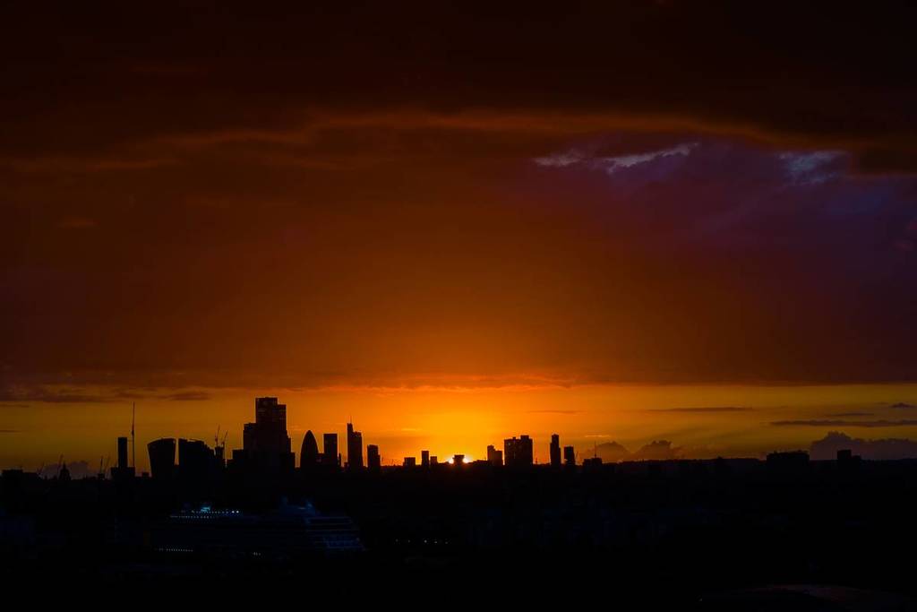 A dramatic orange susets over buildings in London