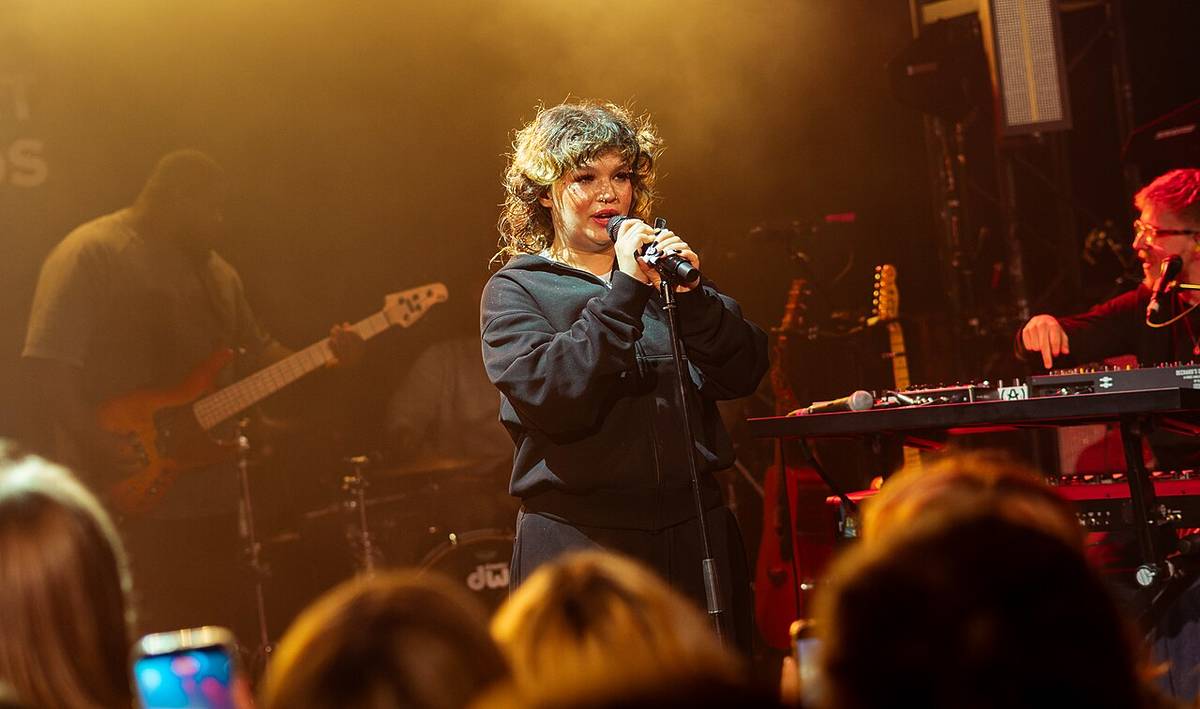 Lola Young in London performing on stage at a live music concert