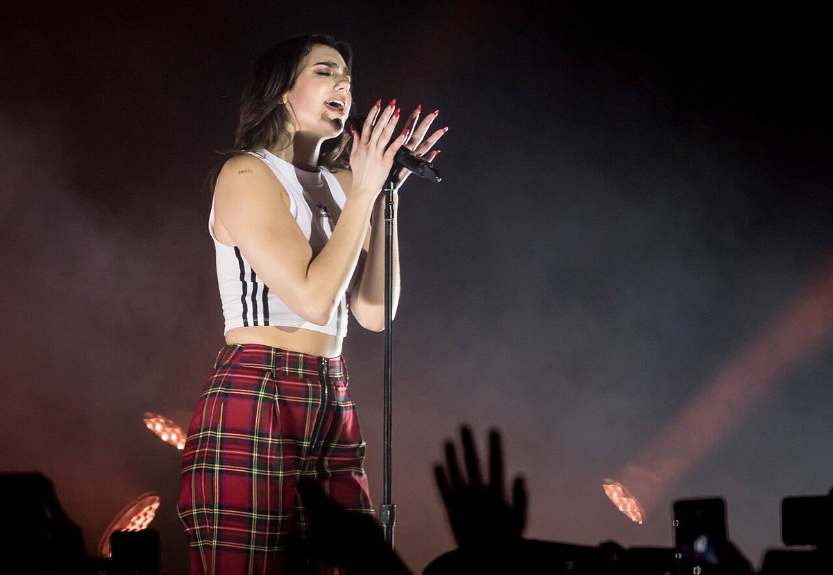 Dua Lipa performing on stage at a concert