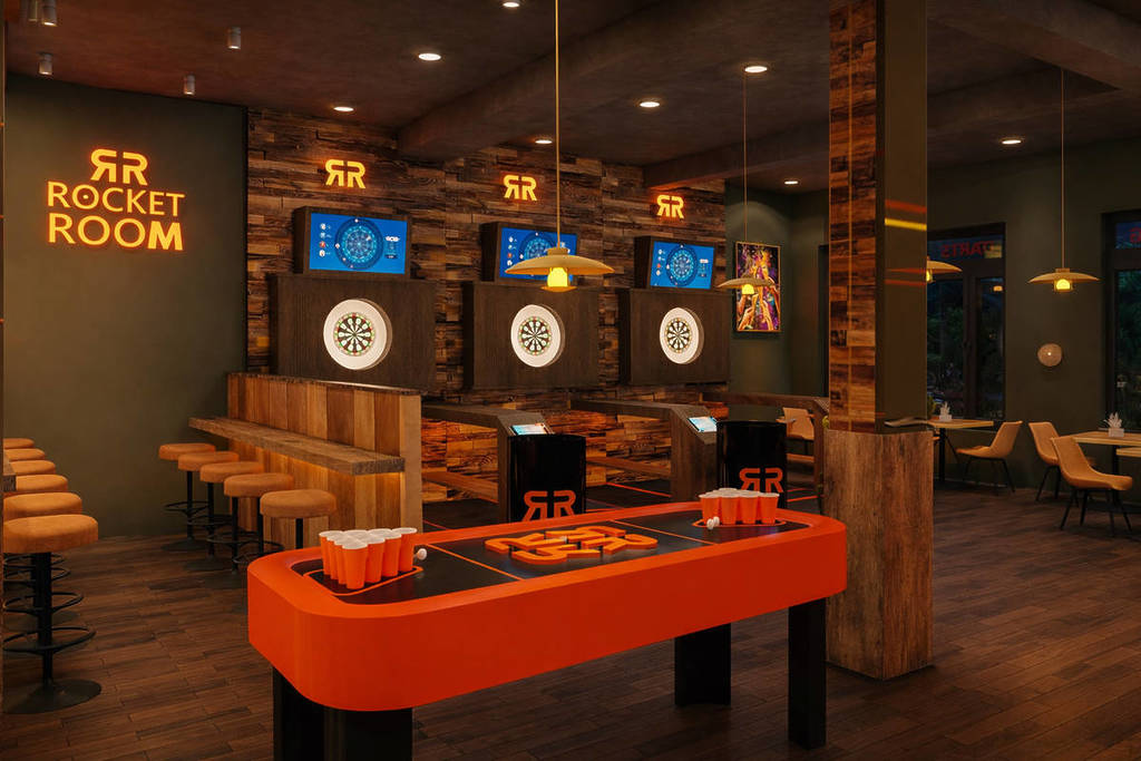 un tavolo da beer pong al centro della sala, con i bersagli delle freccette visibili sullo sfondo