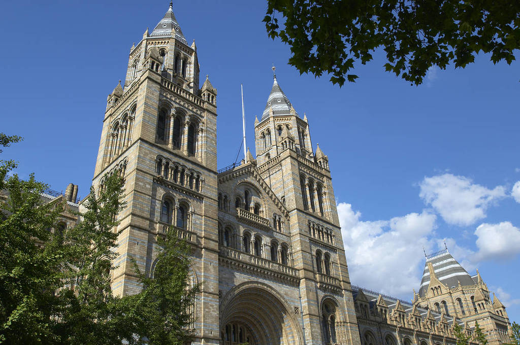 the stunning frontage of the Natural History Museum on a blue sky day