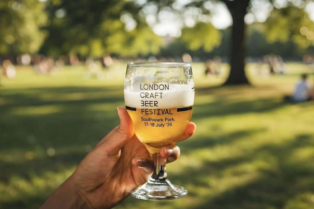 a branded 'london craft beer festival' being held up in a park on a sunny day