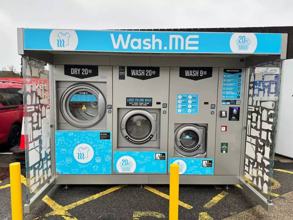 self-service laundry machines in a parking lot