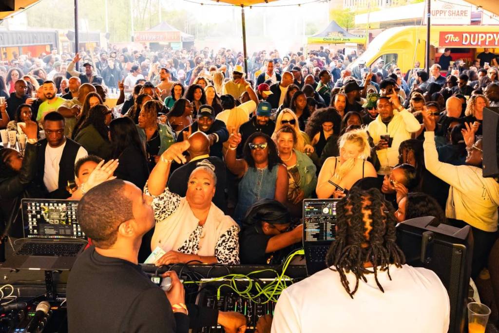 a tent full of people vibing to music at the London Reggae & Food Festival