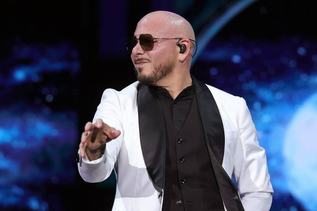 Pitbull in a suit and sunglasses playing live in 2026 at the Stagecoach Festival