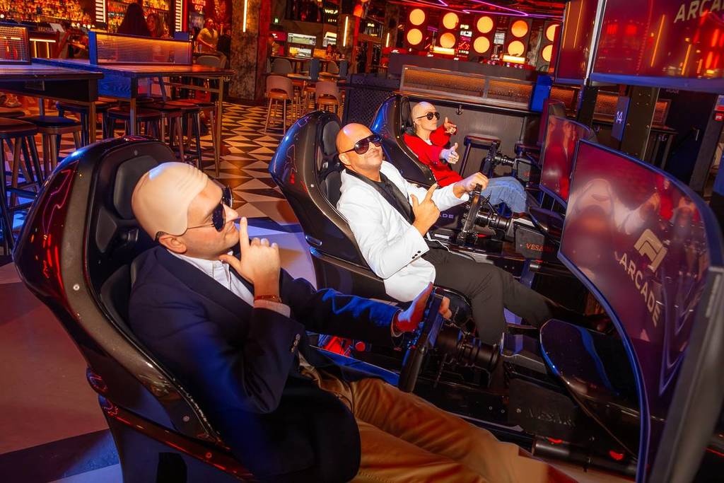 People dressed as Pitbull at the F1® Arcade venue in London