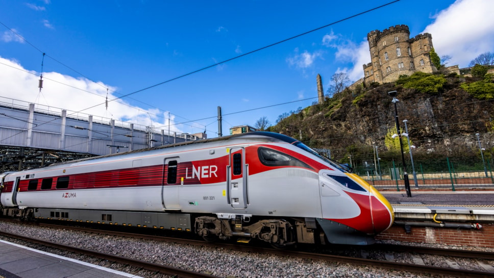 An LNER train passing by Edinburgh Castle