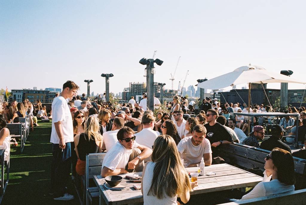 netil 360 rooftop bar in the sun filled with people
