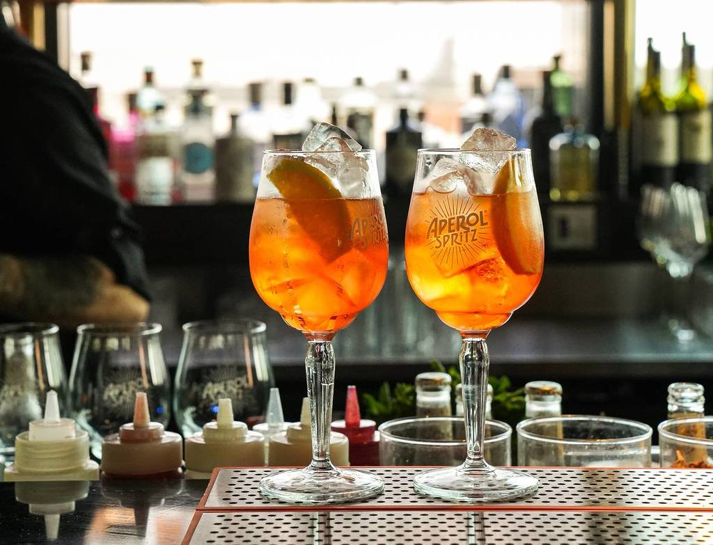 two aperol spritz on a bartop