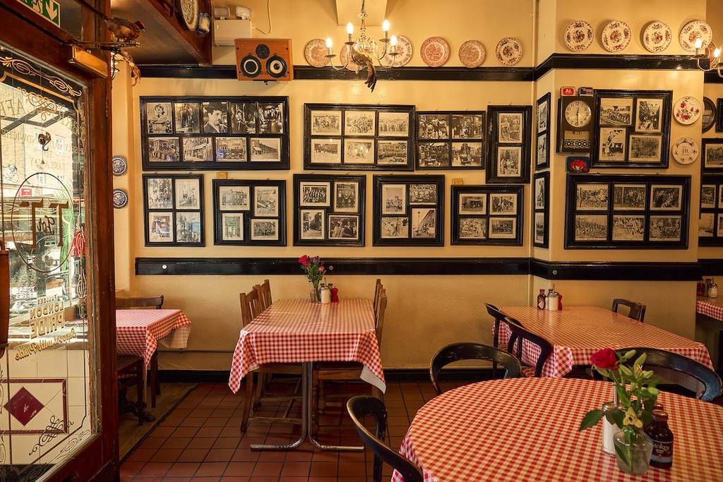 terrys cafe with red terry tablecloths on cafe tables and pictures in frames covering the walls