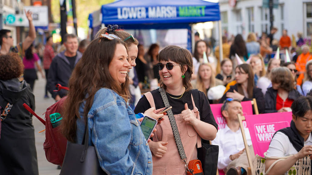 a group of people smiling and enjoying hanging out at the lower marsh lates