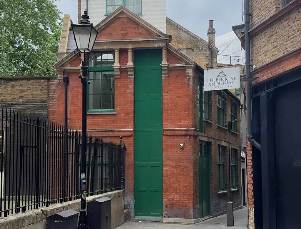 A tall, narrow green door down a side street in London