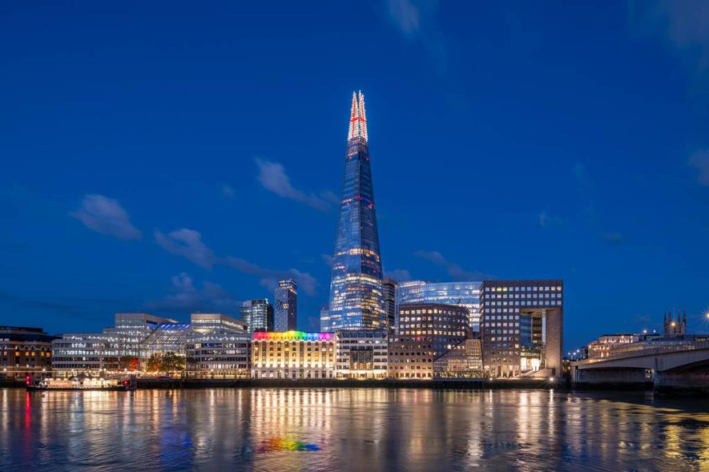Uma vista do Shard iluminado com a bandeira da Inglaterra, do outro lado do rio