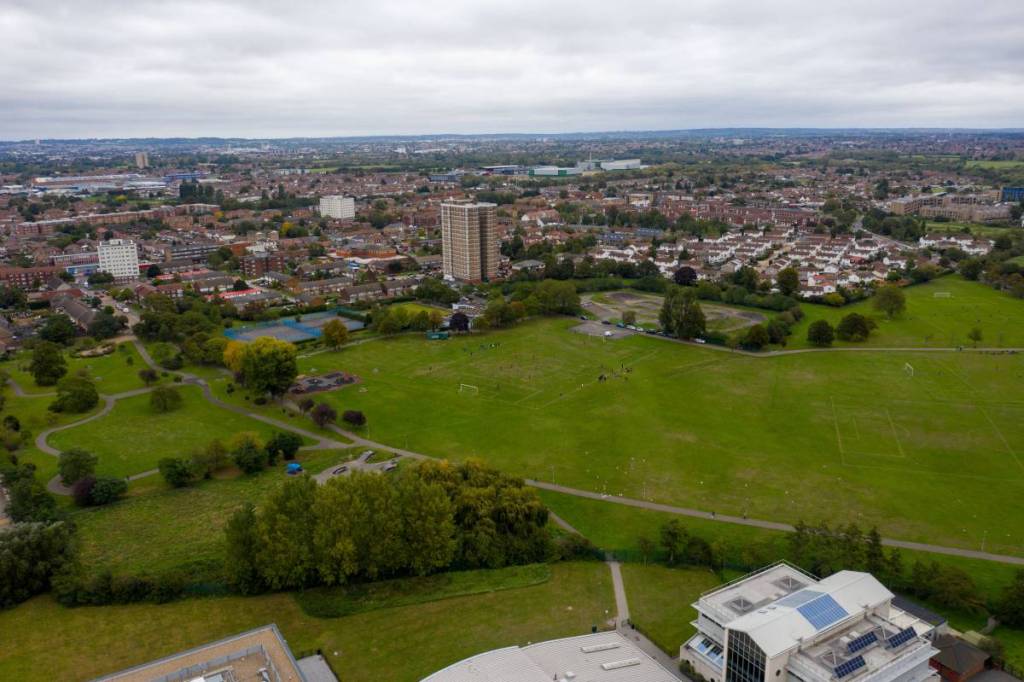 An aerial view of Dagenham Town with a big green space and buildings in the background
